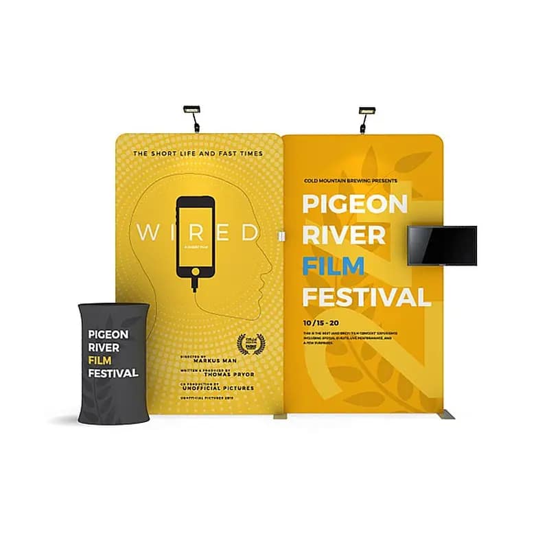 Brightly branded portable display counter showcasing the Pigeon River Film Festival, highlighting trade show furniture