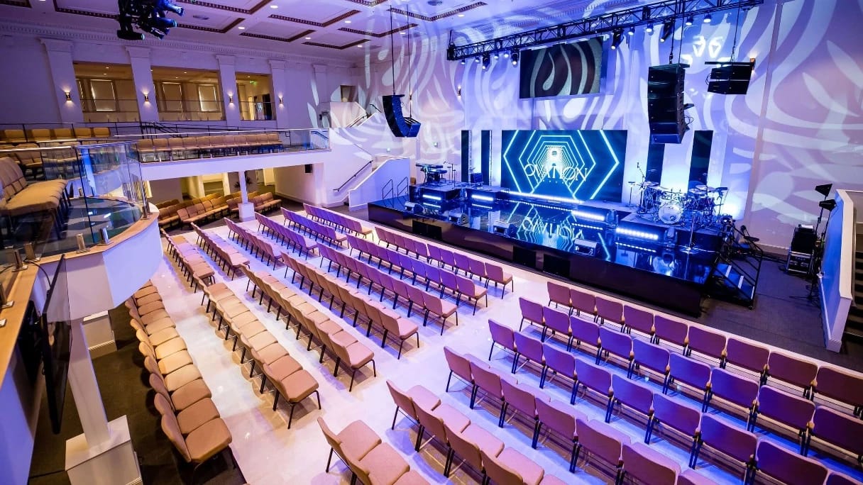 indoor venue with a huge monitor at stagefront