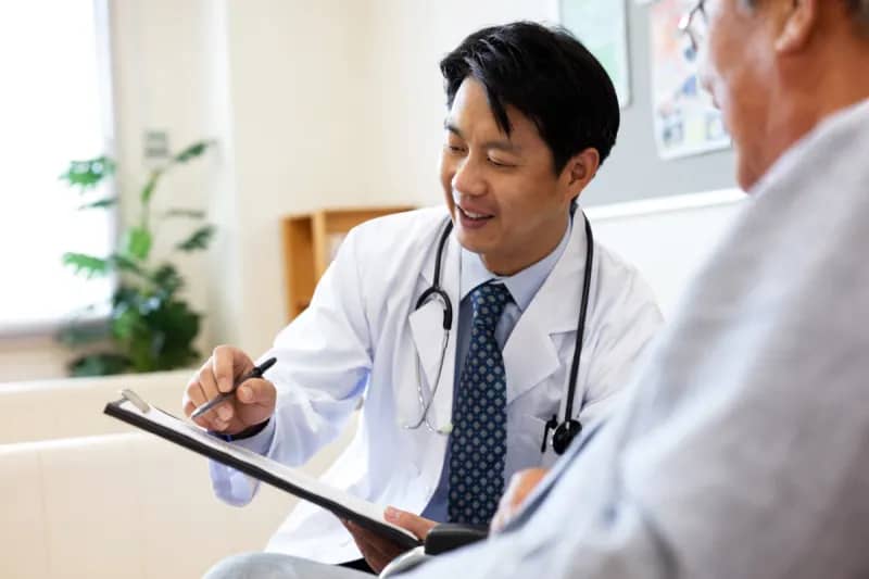 a doctor showing a patient papers