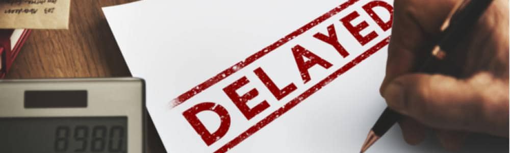 white paper with "DELAYED" in capitals with red marker