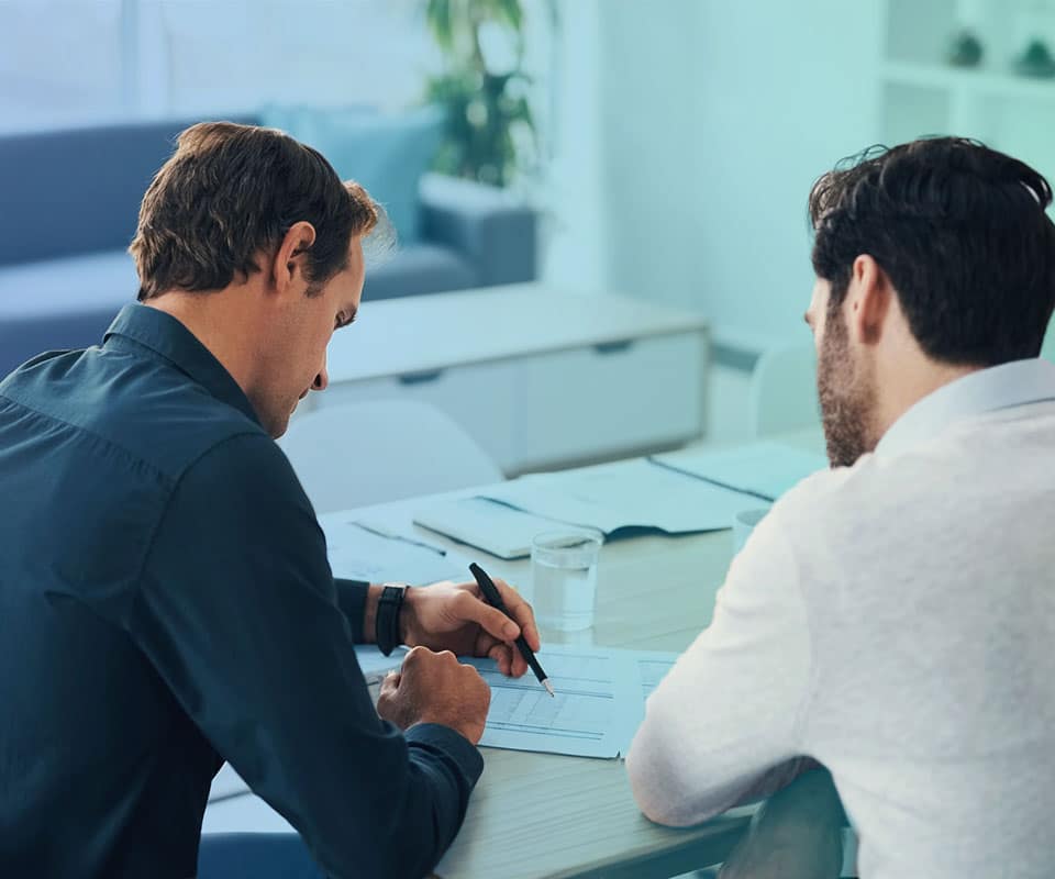 Business discussion between two male coworkers